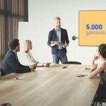 Airtame Present Wirelessly A man presenting wirelessly using Airtame in a room full of people